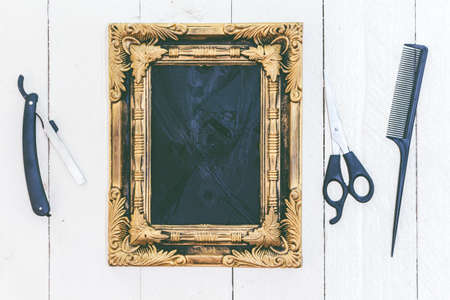 Vintage frame and barber tools on wooden backgroundの写真素材