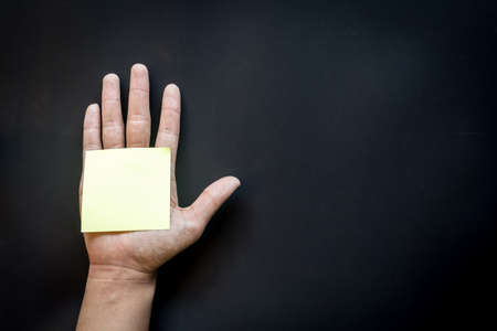 Hand with reminder sticky note ,empty space for textの写真素材