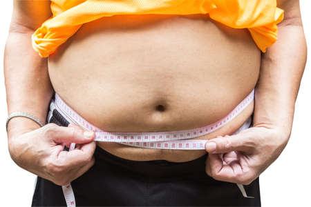 Fat man holding a measuring tape isolated on white background. This has clipping pathの写真素材