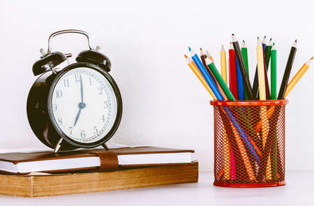 Back to school background with books and alarm clockの写真素材