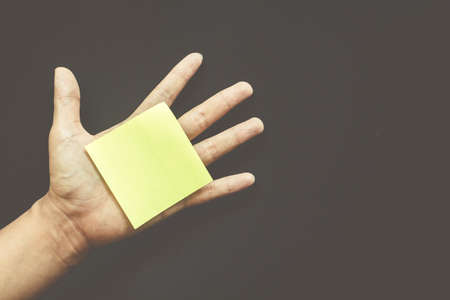 Hand with reminder sticky note ,empty space for textの写真素材