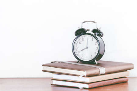Back to school background with books and alarm clockの写真素材