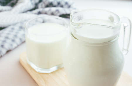 Glass jug and glass with milkの写真素材