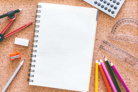 School supplies on the background of the cork boardの写真素材
