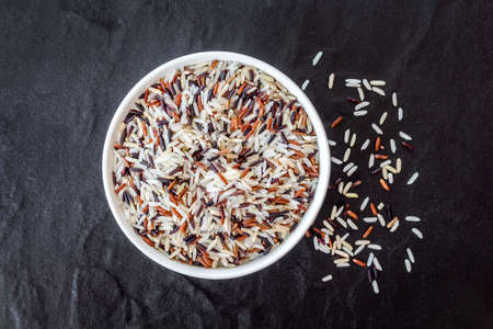 Rice in a bowl on black backgroundの写真素材
