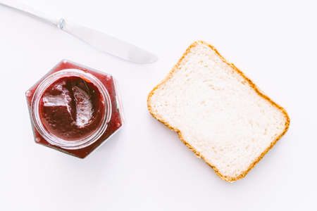 Toast with strawberry jam on white backgroundの写真素材