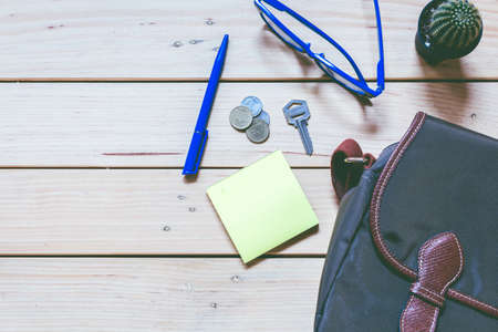 Office supplies and coffee cup on  wooden table with copy spaceの写真素材