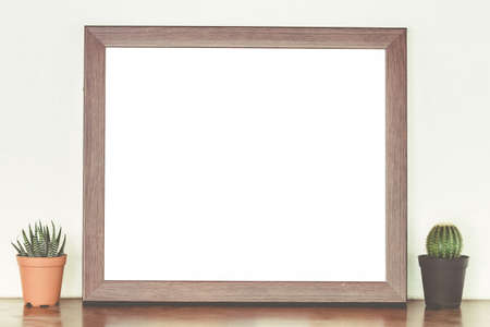 Wooden frames with cactus on tableの写真素材