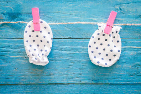 Baby gloves on a wooden backgroundの写真素材