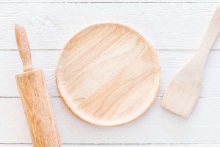Wooden kitchen utensils on white  kitchen tableの写真素材