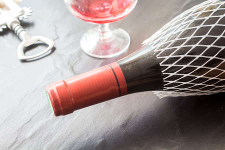 Bottle of wine, glass and corkscrewの写真素材