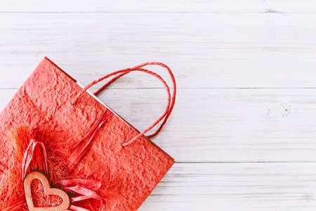 Paper gift bag on wooden tableの写真素材