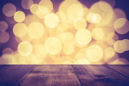 Wood table top on golden bokeh abstract backgroundの写真素材