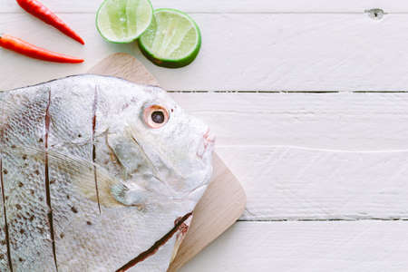 Fresh fish on wooden backgroundの写真素材