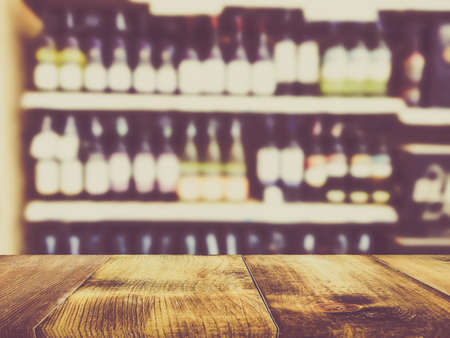 Wooden counter product display with Wine Liquor bottle on shelf, Blurred backgroundの写真素材