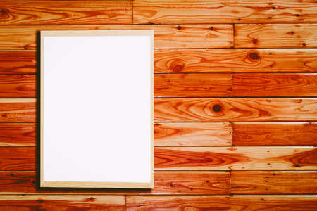 Mock up blank wooden picture frame on wooden wallの写真素材
