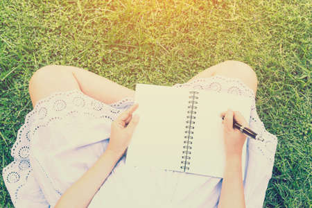 Women write books in the gardenの写真素材