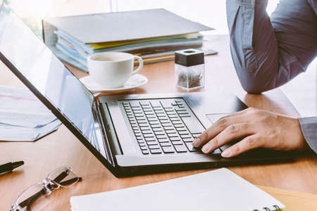 Businessman Using Laptop with coffee