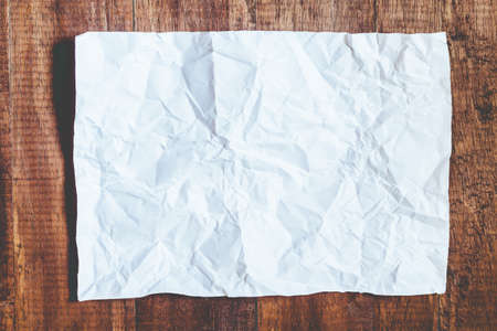 White crumpled paper on wood backgroundの写真素材