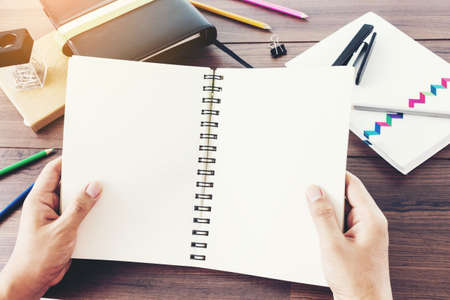 Man reading a book on wooden tableの写真素材