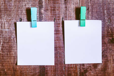 Paper attach to rope with clothes pins on wooden backgroundの写真素材