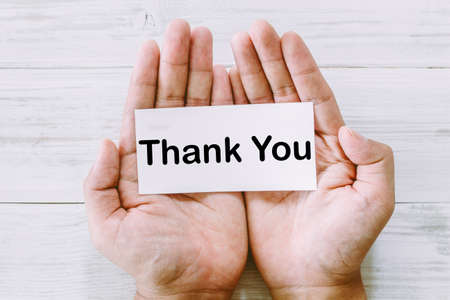 Paper in hand with the words thank youの写真素材