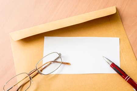 Brown envelope on wooden backgroundの写真素材