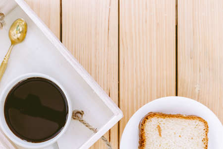 Black coffee and spoon on wooden tableの写真素材