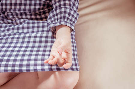 Woman is practicing yoga exercise  on a sofa