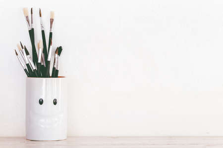Paint brushes on wooden table
