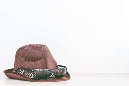 Hat and sunglasses on wooden tableの写真素材