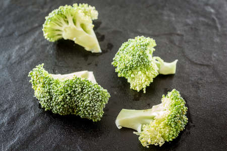 Broccoli on black stone background
