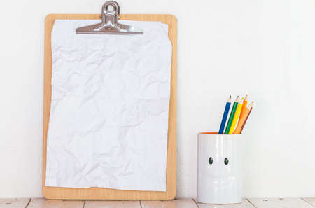Paper in clipboard  on wooden table