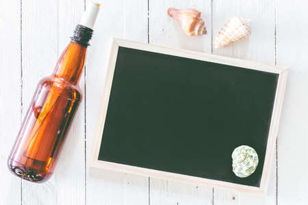 Plastic water bottle and blackboard on the wooden table