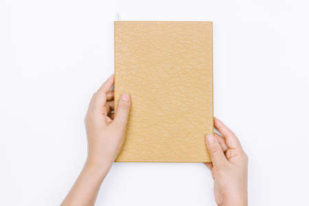 Hands hold the book on white background