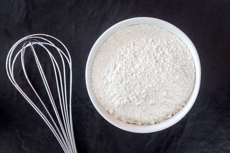 Baking background with flour on black table