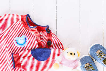 Children clothing on wooden backgroundの写真素材
