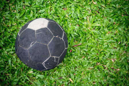 Old soccer ball on green grassの写真素材