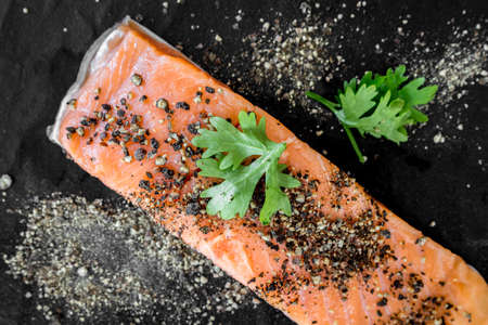 Raw salmon steak  on black backgroundの写真素材