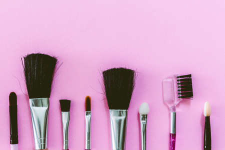 Makeup brush on pink background