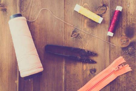 Sewing tools on wooden background