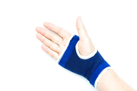 Woman with blue bandage having pain in her wrist isolated on white background