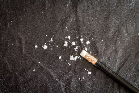 Pencil with eraser dust on  black backgroundの写真素材
