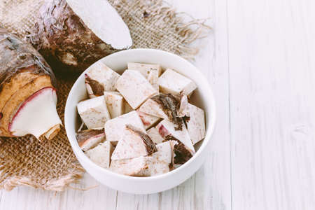 Taro root on wooden backgroundの写真素材