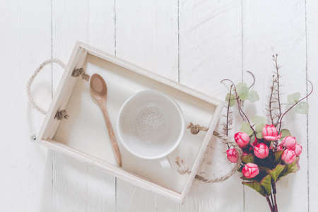 Cup of coffee and spoon on wooden tableの写真素材