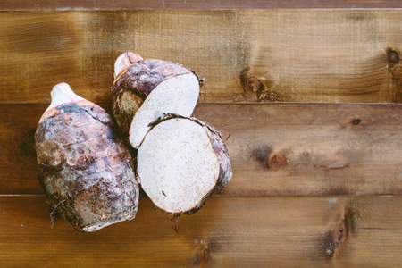 Taro root on wooden backgroundの写真素材