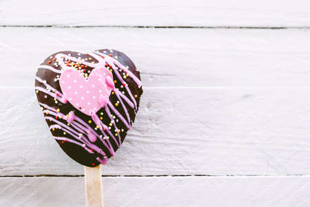 Chocolate hearts on wooden background