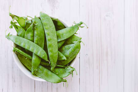 Green pea in bowl on  wooden backgroundの写真素材