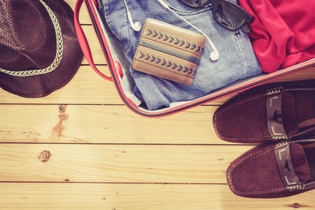 Men's casual  in suitcase on wooden table,Travel Suitcase Man Vacationの写真素材