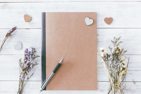 Notebook and dried statice flowers